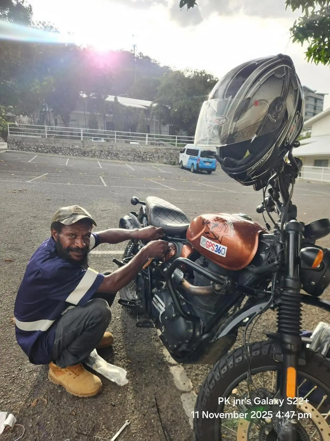 A GPS360 technician installing a tracker on a motorbike in Port Moresby